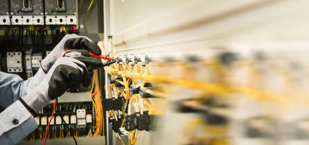istock Electrical engineers test electrical installations and wiring on protective relays, measuring them with a multimeter. 1500226936
