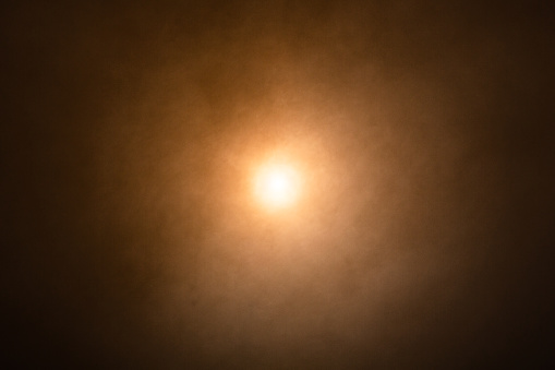 Orange smoke or fog with a light source in the center