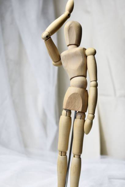 istock Vertical of a wooden mannequin on a white background 1500228501