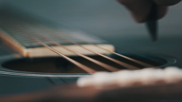 Vibration Metalic Strings on an Acoustic Guitar in Slow Motion, Close-Up