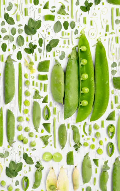 Pea and Pod vegetable piece, slice and leaf collection. Flat lay, seamless abstract on white wooden background.