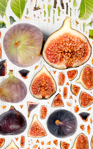Fig fruit piece, slice and leaf collection. Flat lay, seamless abstract on wooden background.