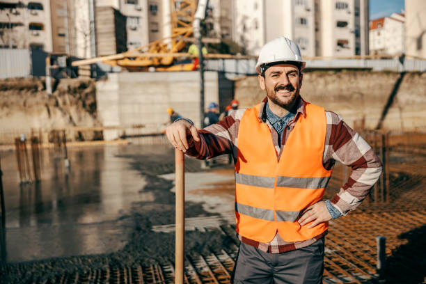 istock A happy site worker is leaning on shovel and smiling at the camera on site during concreting building foundation. 1500235706