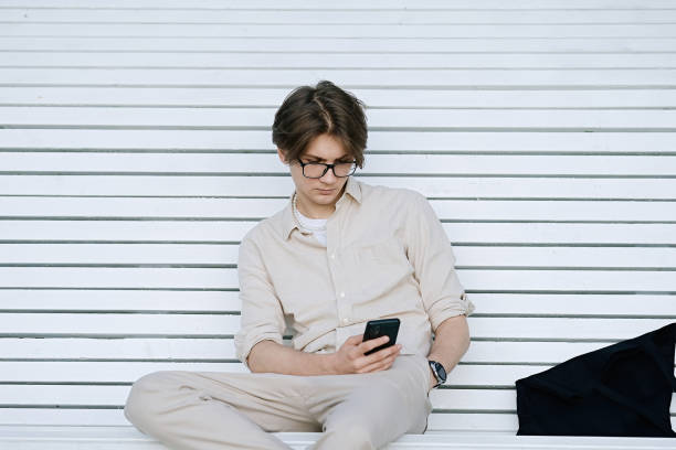istock Young man chatting on a mobile phone 1500235773