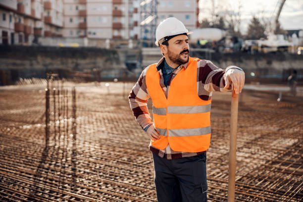 istock A hardworking site worker is leaning on shovel and looking around site while standing on building foundation. 1500235883
