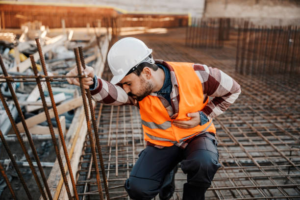 istock A site worker is crouching and touching his painful stomach. 1500236012
