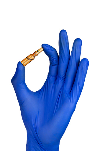 Hand in blue glove holding an ampoule isolated on white background.