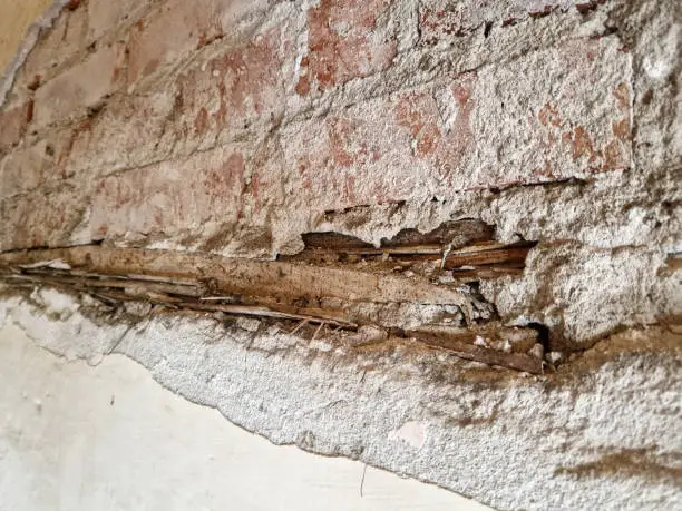 Plaster falls off an old wall