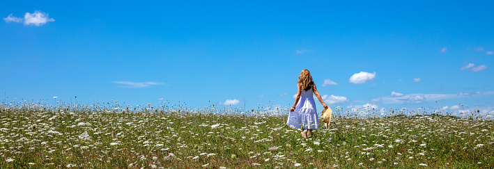 Young woman with white dress in field with flowers- freedom, health concept