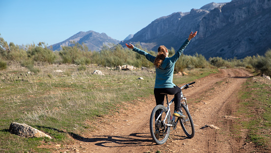 Woman in mountain bike in countryside