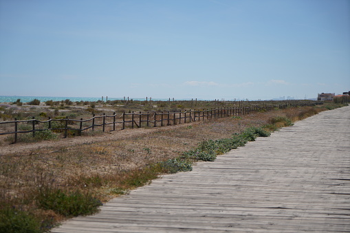 Path to the Mediterranean beach with sunshine and blue sky