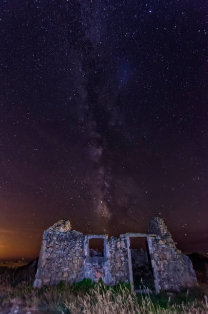istock Night sky and the milky way over old abandoned house 1500244420