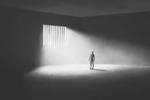 istock Illustration of prisoner looking the light coming from outside the bars, abstract redemption concept 1500245872