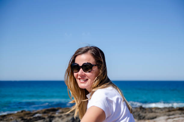 istock girl enjoying the sea scenery 1500246196