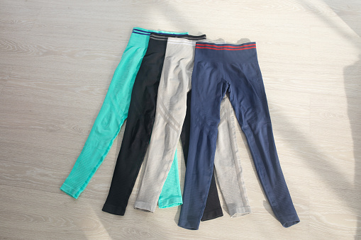 Colourful sports leggings isolated on grey background.