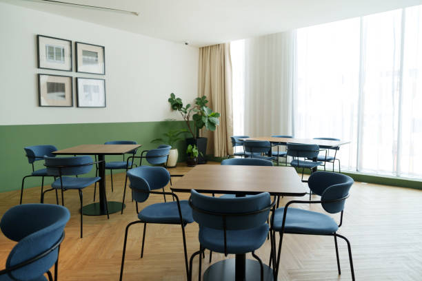Modern office cafeteria interior with a comfortable chairs and tables