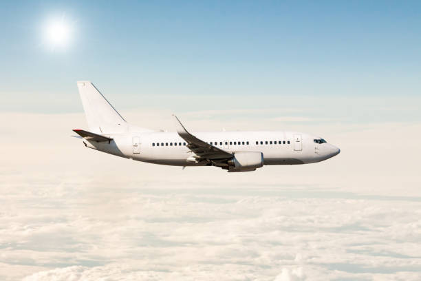 istock White passenger jet plane flies in the air above the clouds 1500248747
