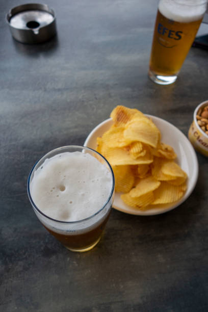 istock Beer glass and potato chips in a bowl shot 1500249221