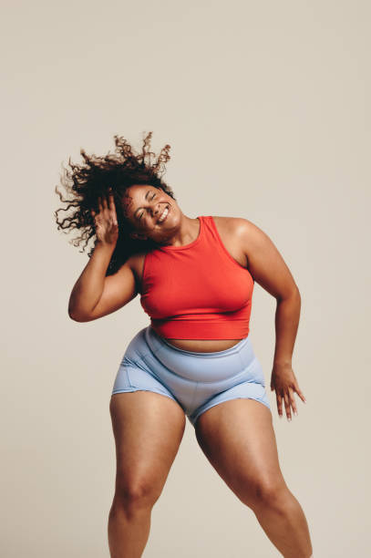 istock Curvy woman doing fun body movements in a dance workout session 1500254185