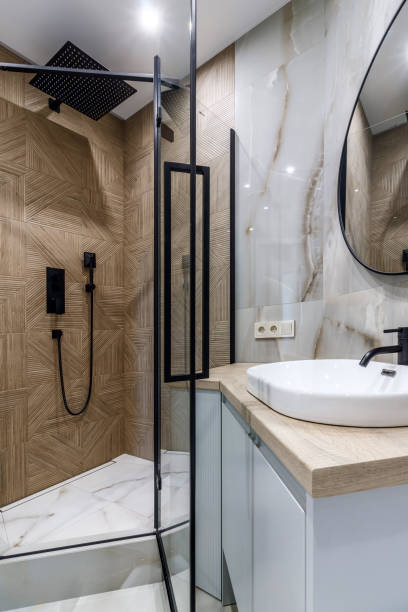 istock Modern bathroom with black fixtures, mirror and white sink 1500254527