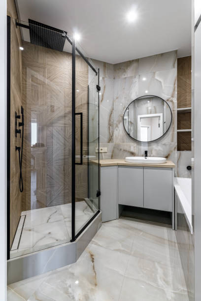 istock Modern bathroom with black fixtures, mirror and white sink 1500254533