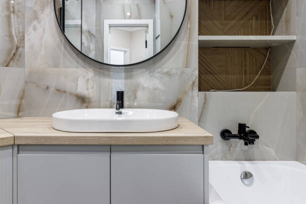 istock Modern bathroom with black fixtures, mirror and white sink 1500254561
