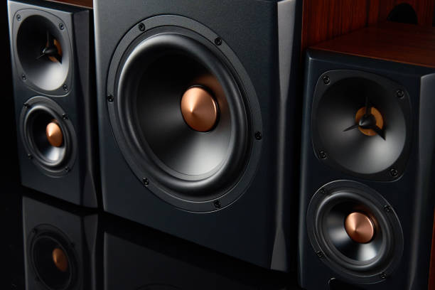 istock Sound audio system with two satellites and subwoofer on dark background. 1500259725