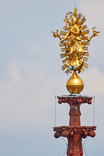 golden figure of Mary on the spire of the Marienkapelle in Wuerzburg, Bavaria.