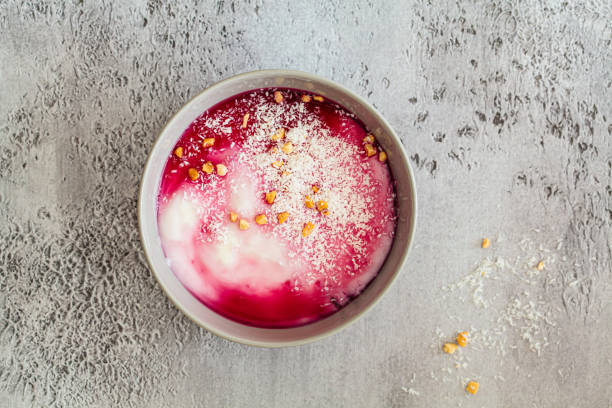 Malabi - traditional Arabic dessert. Milk pudding with rose syrup and nuts, top view.