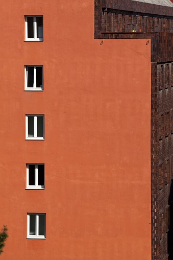 A minimalist European building with side windows.