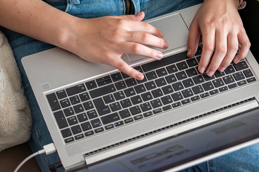 young person typing on computer,learning,hands on laptop keyboard,Freelancer using laptop at home, closeup,Close up of a woman hands typing on laptop keyboard