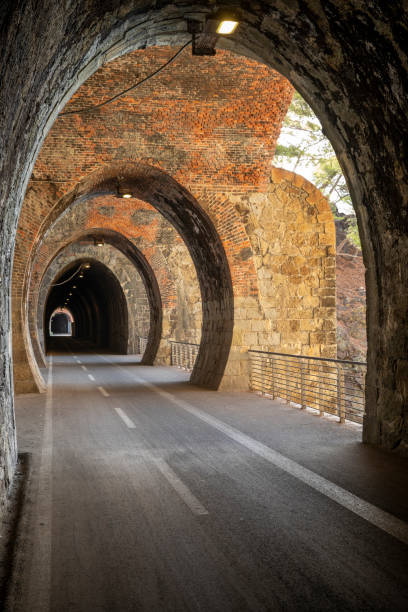 istock Cycle path in Liguria built on the old train route. Tunnel made from red bricks 1500264538