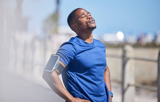 istock Fitness, training and tired man runner outdoors for break from exercise, cardio or running on blurred background. Workout, stop and breathe by athletic male outside for marathon, run or sport routine 1500282068