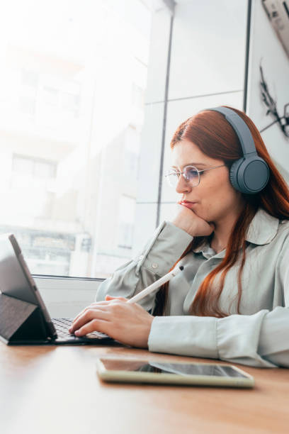 istock Redhead Girl. Work Anywhere: Red-haired Trailblazer Redefines Remote Productivity 1500284008