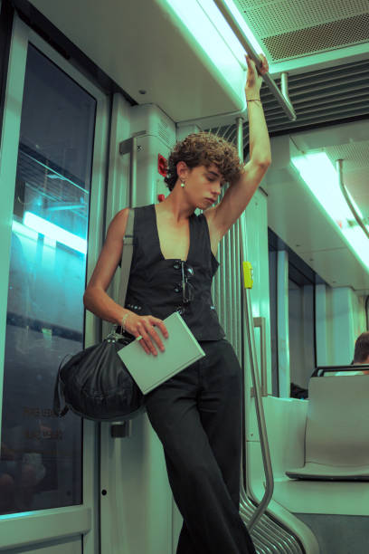 istock Young gay man with a book is posing in a subway 1500284425