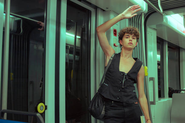 istock Young gay man with a book is posing in a subway 1500284503