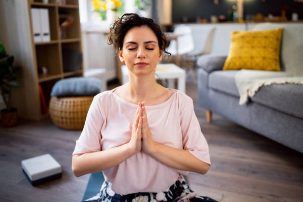 istock Young woman practicing yoga at home 1500285876