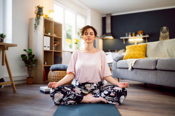 istock Young woman practicing yoga at home 1500285897
