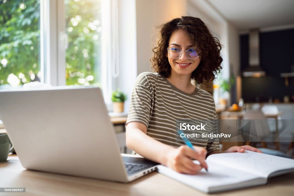 Young woman, a university student, studying online. Learning Stock Photo