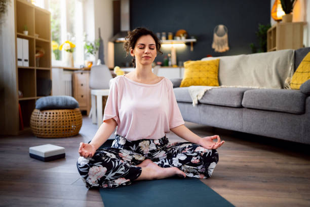 istock Young woman practicing yoga at home 1500285928