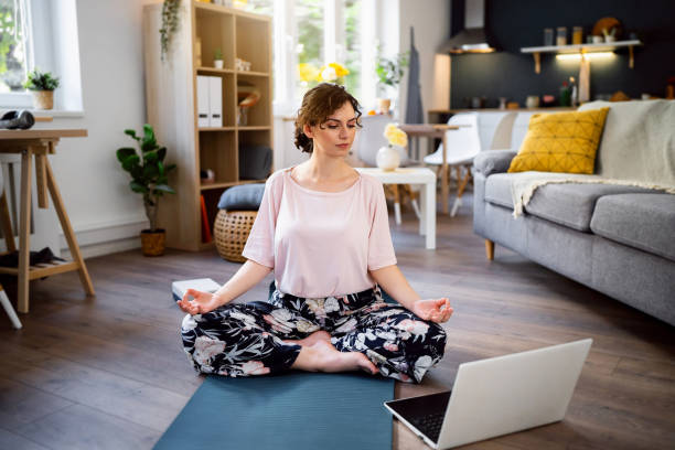 istock Young woman practicing yoga at home 1500285939