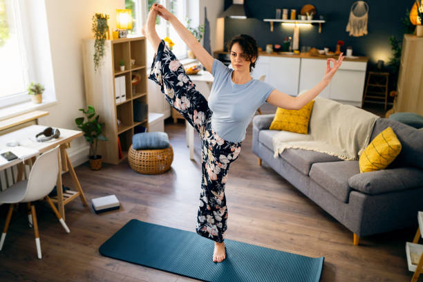istock Young woman practicing yoga at home 1500286199