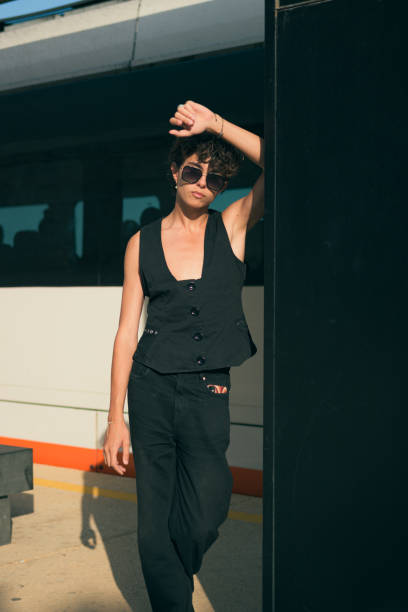 istock Young alternative man in black clothes posing in a station at sunset 1500286736