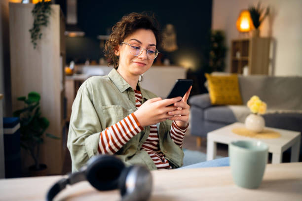 Young Caucasian woman texting messages on her phone