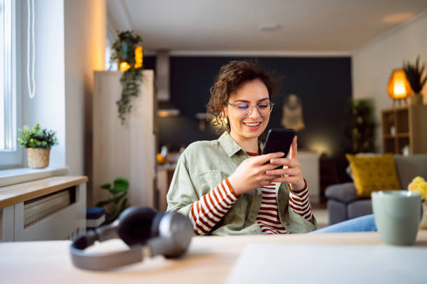 istock Beautiful young woman texting messages on her phone 1500286900