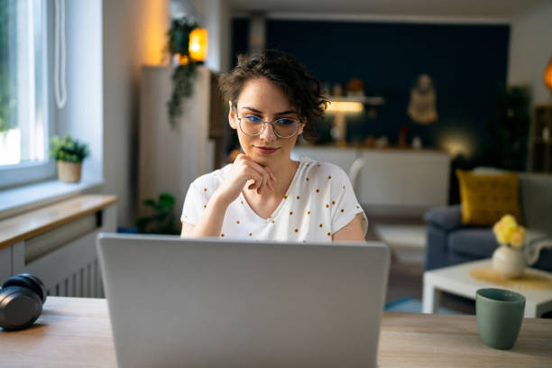 istock Young Caucasian woman working on laptop from her home 1500287691