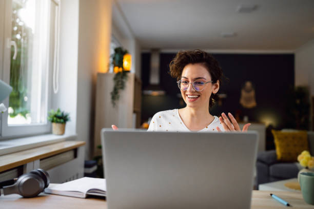 istock Young working woman having a video call over laptop from her home 1500288034