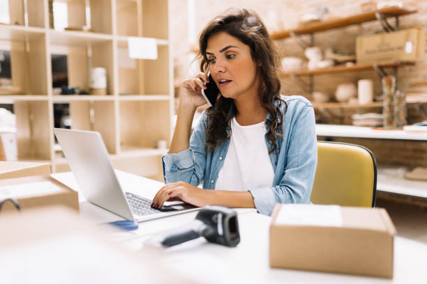 istock Female entrepreneur speaking on the phone in a warehouse 1500288582