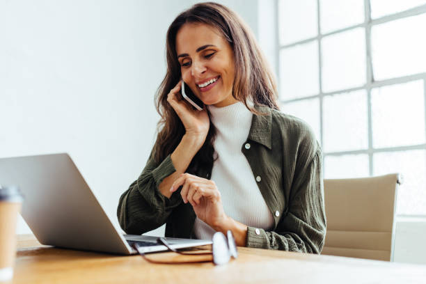 istock Business woman talking on the phone at work 1500288989