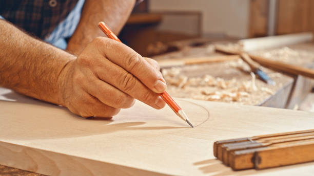 istock Male carpenter's hand drawing on wooden plank 1500290814